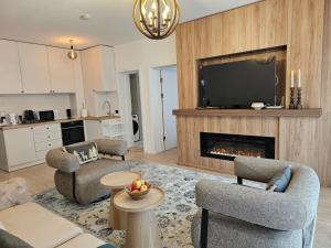 a living room with a tv and a fireplace at Mountain Whisper Chalet in Braşov