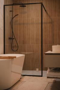 a bathroom with a shower and a toilet and a sink at Mountain Whisper Chalet in Braşov +44 photos