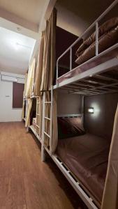 a room with several bunk beds in a room at Zanit Hostel in Don Muang Airport