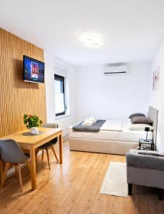 a living room with a bed and a table at Apartments Repinc in Bled