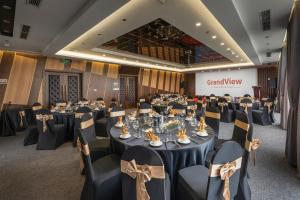 a banquet hall with tables and chairs in a room at GrandView Hotel & Residence Hanoi in Hanoi