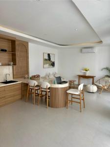 a kitchen with a table with a laptop on it at Villa Lipa in Ungasan