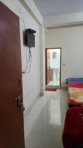 a room with a bed and a bathroom with a toilet at Krishna guest house in Mussoorie