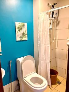 a bathroom with a toilet and a shower at Horizons 101-Premium Studio 42J in Cebu City +12 photos
