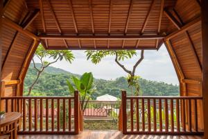 a view from the deck of a resort with a view of the mountains at Kubu Diar by Manara in Seraya