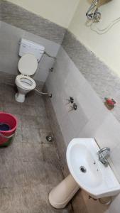 a bathroom with a toilet and a sink at Krishna guest house in Mussoorie