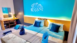 a bedroom with two beds with blue pillows at Horizons 101-Premium Studio 42J in Cebu City