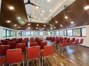 a room with red chairs and tables in it at Dreamland View Resort in Cochin