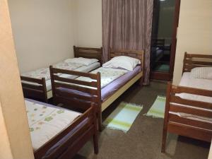 a room with three beds and a mirror at Planinski dom Kal in Dol pri Hrastniku