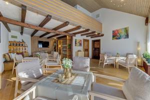 a dining room with white chairs and a table at Hotel Haus Anna in Bayerisch Eisenstein