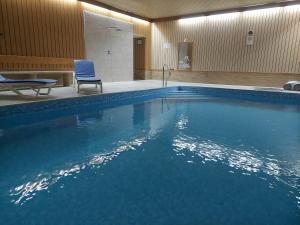 a large swimming pool with a chair and a chair at Hotel Haus Anna in Bayerisch Eisenstein