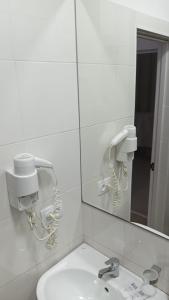 a bathroom with a mirror and a sink at Гостиница"Hostel" in Karagandy