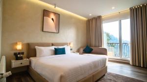 a bedroom with a large bed and a large window at Zesora Nathia Gali in Nathia Gali +26 photos