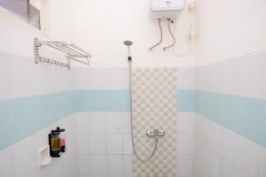 a bathroom with a shower with a shower at RedDoorz at Jestro Guest House Batu in Tlekung +61 photos