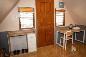 a tiny house with a desk and a table at Lukay Guest House in Siquijor in Lazi