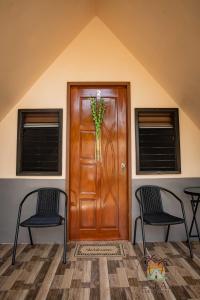 a wooden door with a vase of flowers on it at Lukay Guest House in Siquijor in Lazi