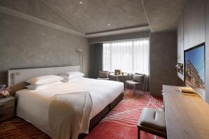 a hotel room with a large bed and a desk at THE HOTEL HIGASHIYAMA KYOTO TOKYU, A Pan Pacific Hotel in Kyoto