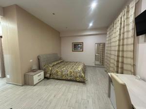 a bedroom with a bed and a dresser and a television at La Suite in Cassino