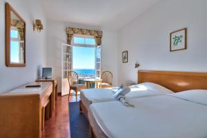 Postel nebo postele na pokoji v ubytování Hotel Monte Carlo