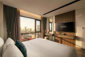 a hotel room with a bed and a large window at GrandView Hotel & Residence Hanoi in Hanoi +70 photos