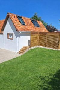 a house with an orange roof with a yard at Le Gîte de Clément avec Spa privatif in Courset