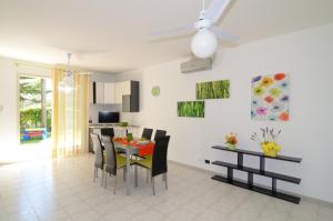 a kitchen and dining room with a table and chairs at Casa Michelangela in Mascali