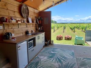 a kitchen with a counter and a view of a vineyard at Villas & Vines Glamping in Hastings
