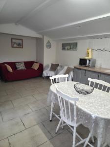 a kitchen and a living room with a table and chairs at Le chemin du bonheur in Nyons
