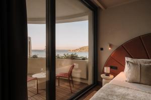 a bedroom with a bed and a view of the ocean at Hotel Kali in Kali +73 photos