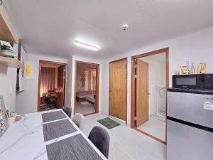 a kitchen and dining room with a table and a refrigerator at Your Stay in Seoul
