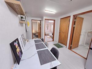 a dining room with a long table and chairs at Your Stay in Seoul