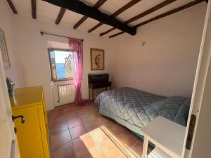 a bedroom with a bed and a window at Luce su Civita in Lubriano