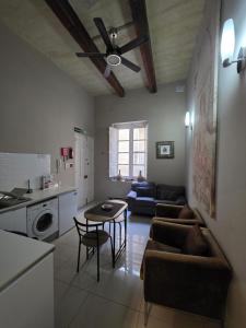 a living room with a couch and a table at Charming Valletta Escape Unesco Area in Valletta +25 photos