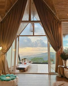 a living room with a large window with a view at Doi Chang Triple A Coffee in Ban Huai Khai