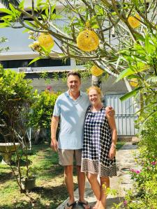 a man and a woman standing under a tree at Anu Villa Wadduwa in Wadduwa