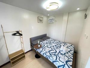 a bedroom with a bed and a table in it at Potot Haven Dorm and Transient in Libmanan