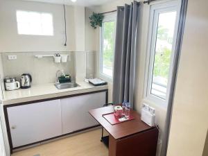 a small kitchen with a sink and a table at Potot Haven Dorm and Transient in Libmanan