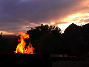 a fire is burning in front of a sunset at Nardouw in Clanwilliam