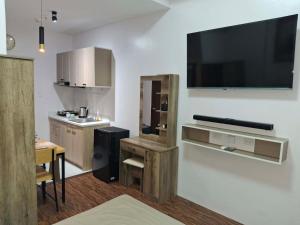 a kitchen with a large flat screen tv on a wall at Casa Aurora in Mandaue City