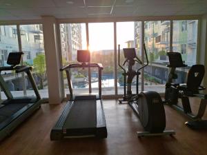 a gym with cardio machines and a large window at Casa Aurora in Mandaue City