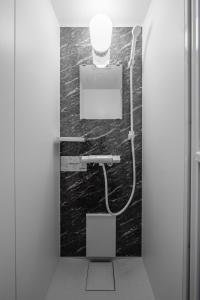 a bathroom with a sink and a light on the wall at Hills Niseko B in Niseko