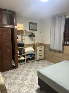 a room with a bedroom with a bed and a dresser at Refúgio ao mar in Rio das Ostras +12 photos
