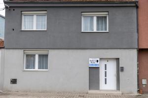 a gray house with a sign on the door at Bakina kuca in Pirot