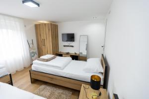 a bedroom with a bed and a tv in it at Bakina kuca in Pirot