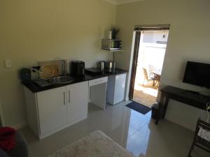 a kitchen with a sink and a counter top at the range in Langebaan