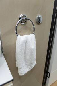 a white towel hanging on a towel rack in a bathroom at Bakina kuca in Pirot +33 photos