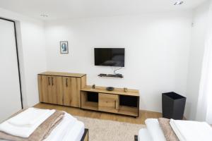 a living room with a tv and a wooden cabinet at Bakina kuca in Pirot