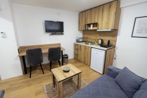 a living room with a couch and a table and a kitchen at Bakina kuca in Pirot