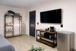 a living room with a flat screen tv on a wall at Depto Tec by tuhost in Monterrey +16 photos