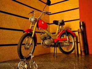 a red motorcycle parked next to a wall at B&B Omer in Sciacca